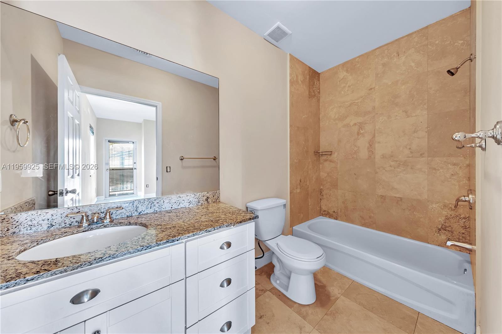 4025 Southwest 10th Street Miami, FL 33134 - Photo 32 of 41 a bathroom with a granite countertop sink a toilet and bathtub