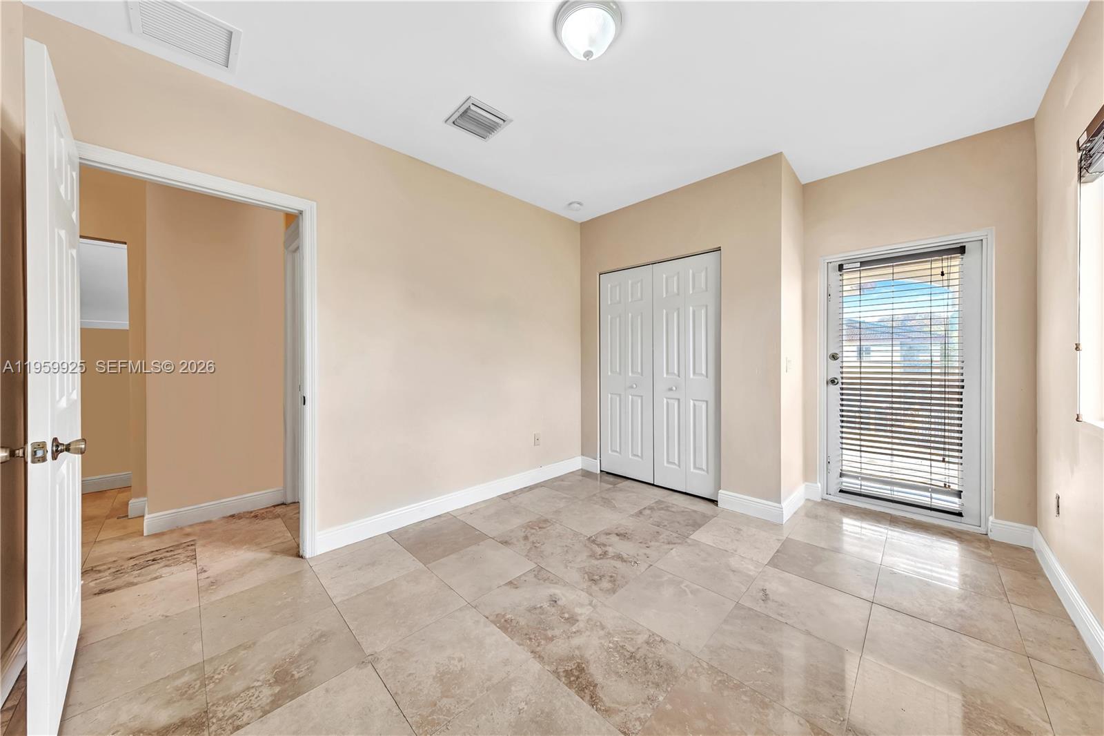 4025 Southwest 10th Street Miami, FL 33134 - Photo 33 of 41 a view of an empty room with wooden floor and a bathroom