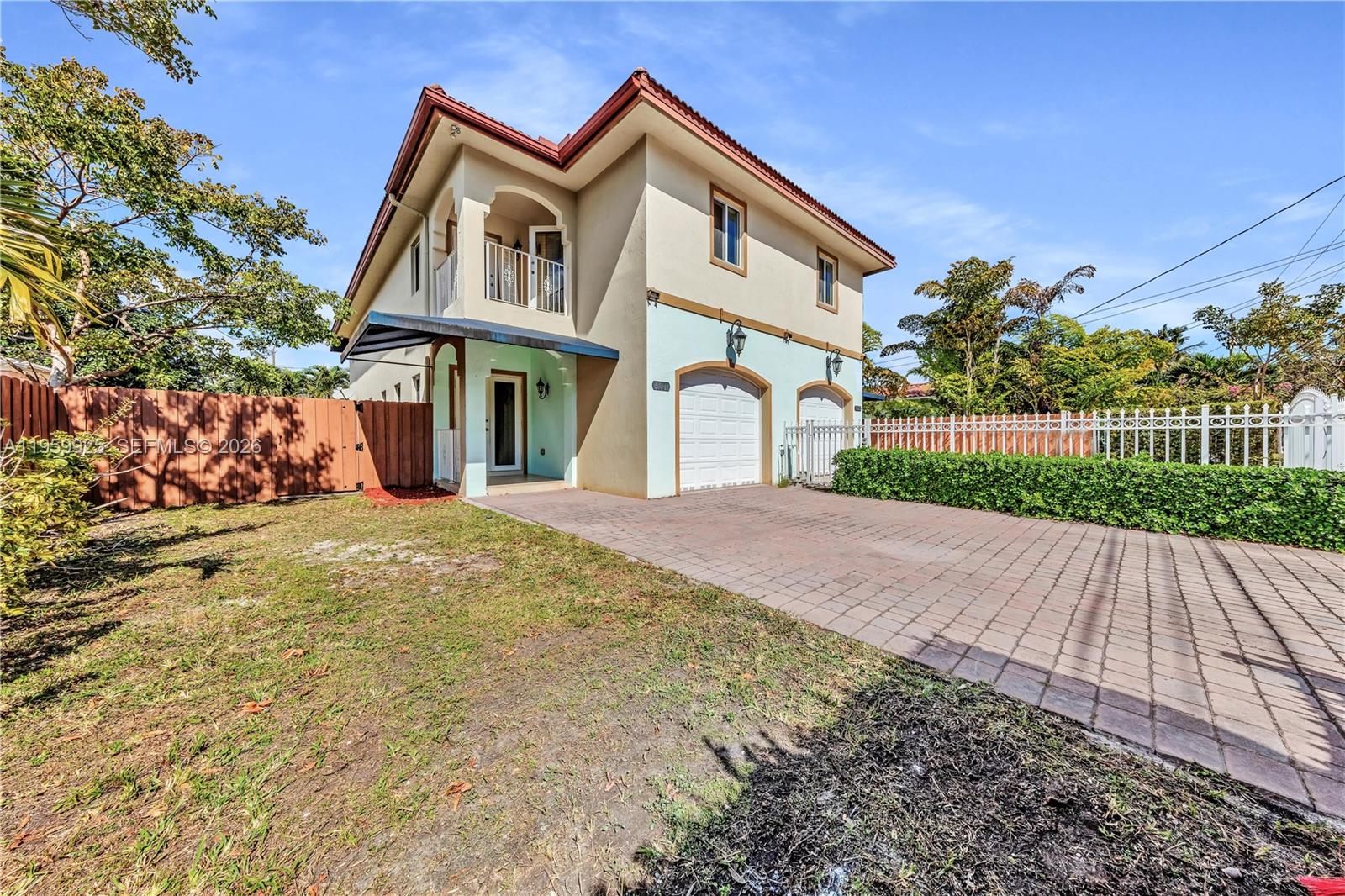 4025 Southwest 10th Street Miami, FL 33134 - Photo 5 of 41 a front view of a house with a yard and potted plants