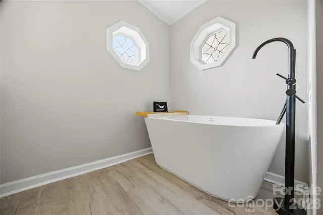 a white tub sitting next to a window
