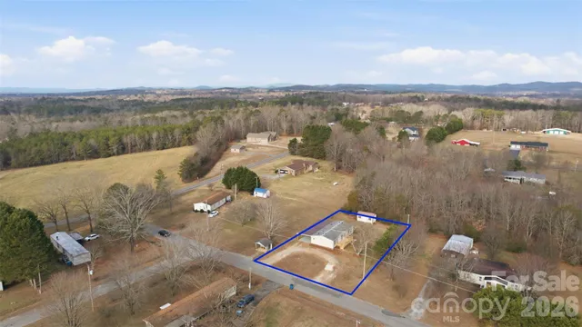 an aerial view of a house with a lake view