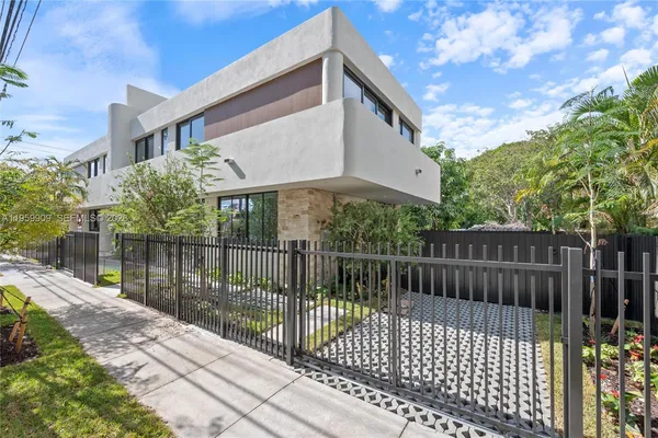 a view of a house with a wooden fence