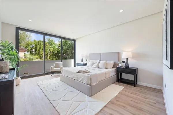 a bedroom with a large bed and a large window