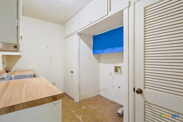 a room with a table and a refrigerator