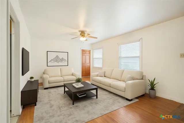 a living room with furniture and a flat screen tv