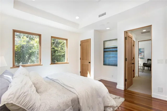 a living room with furniture a large window and a table
