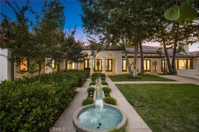 a backyard of a house with a yard and outdoor seating