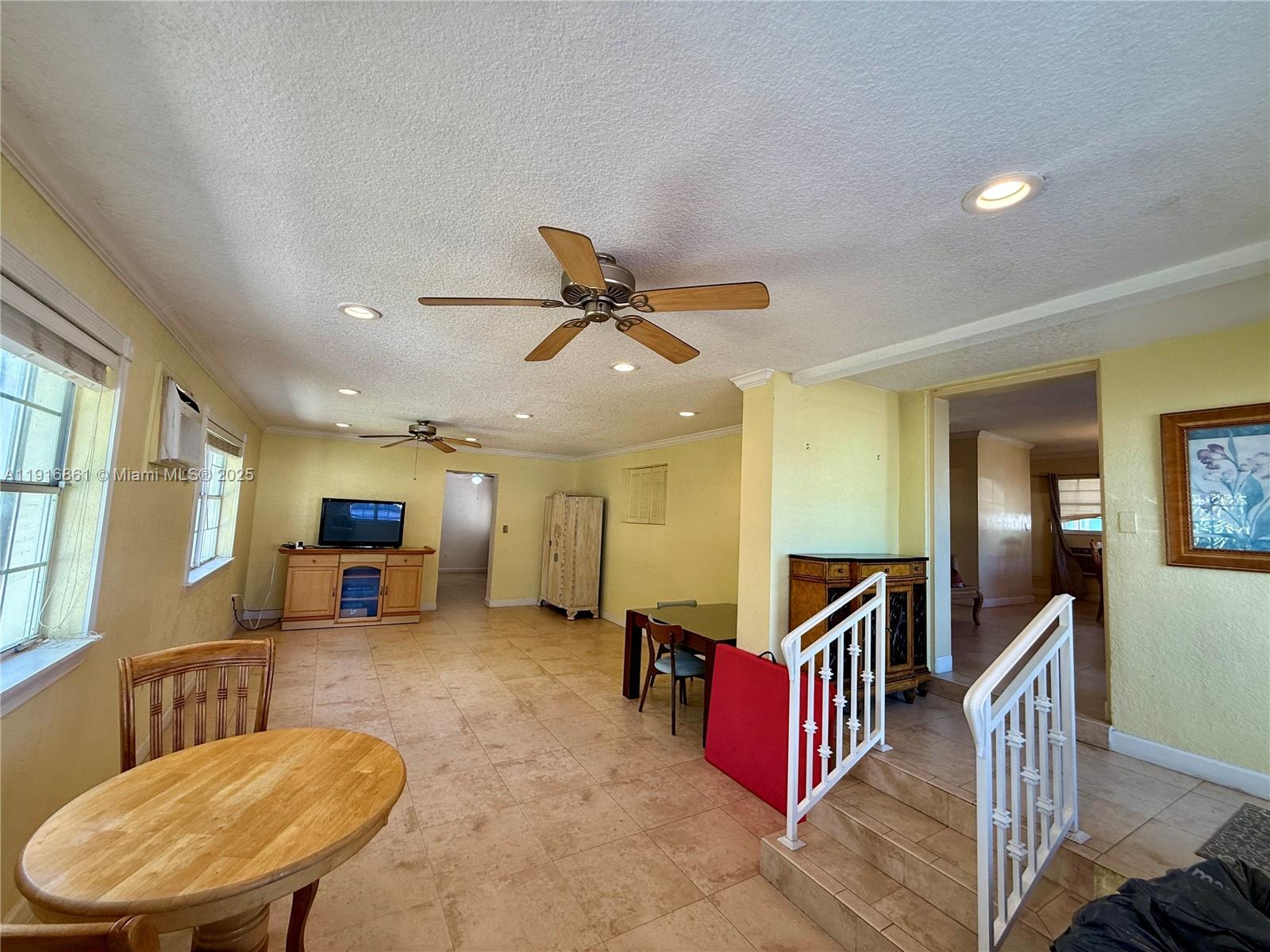 174 East 41st Street Hialeah, FL 33013 - Photo 11 of 46 a living room with furniture ceiling fan and a wooden floor