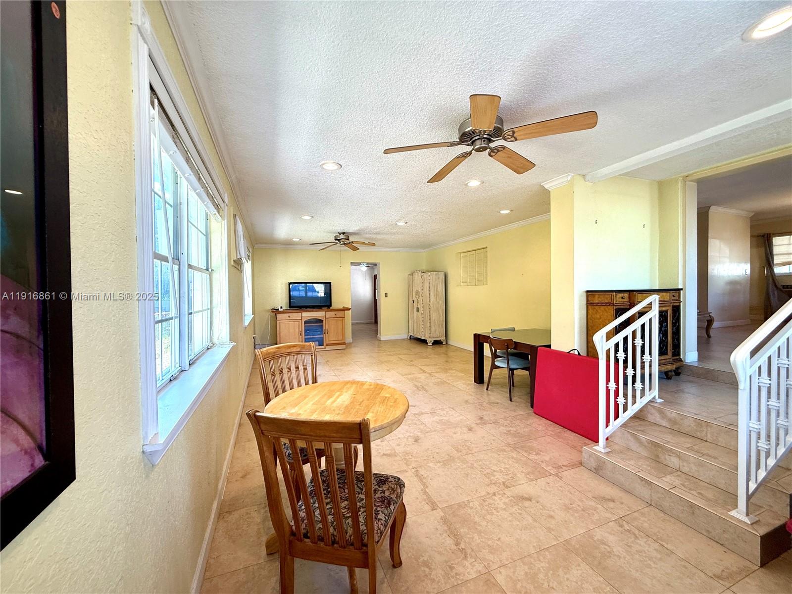174 East 41st Street Hialeah, FL 33013 - Photo 12 of 46 a dining room with furniture and a chandelier