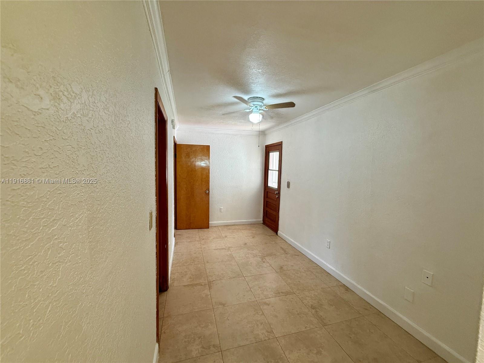 174 East 41st Street Hialeah, FL 33013 - Photo 15 of 46 an empty room with a ceiling fan and a window