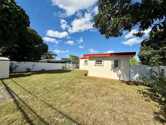 a view of a house with a yard and garage