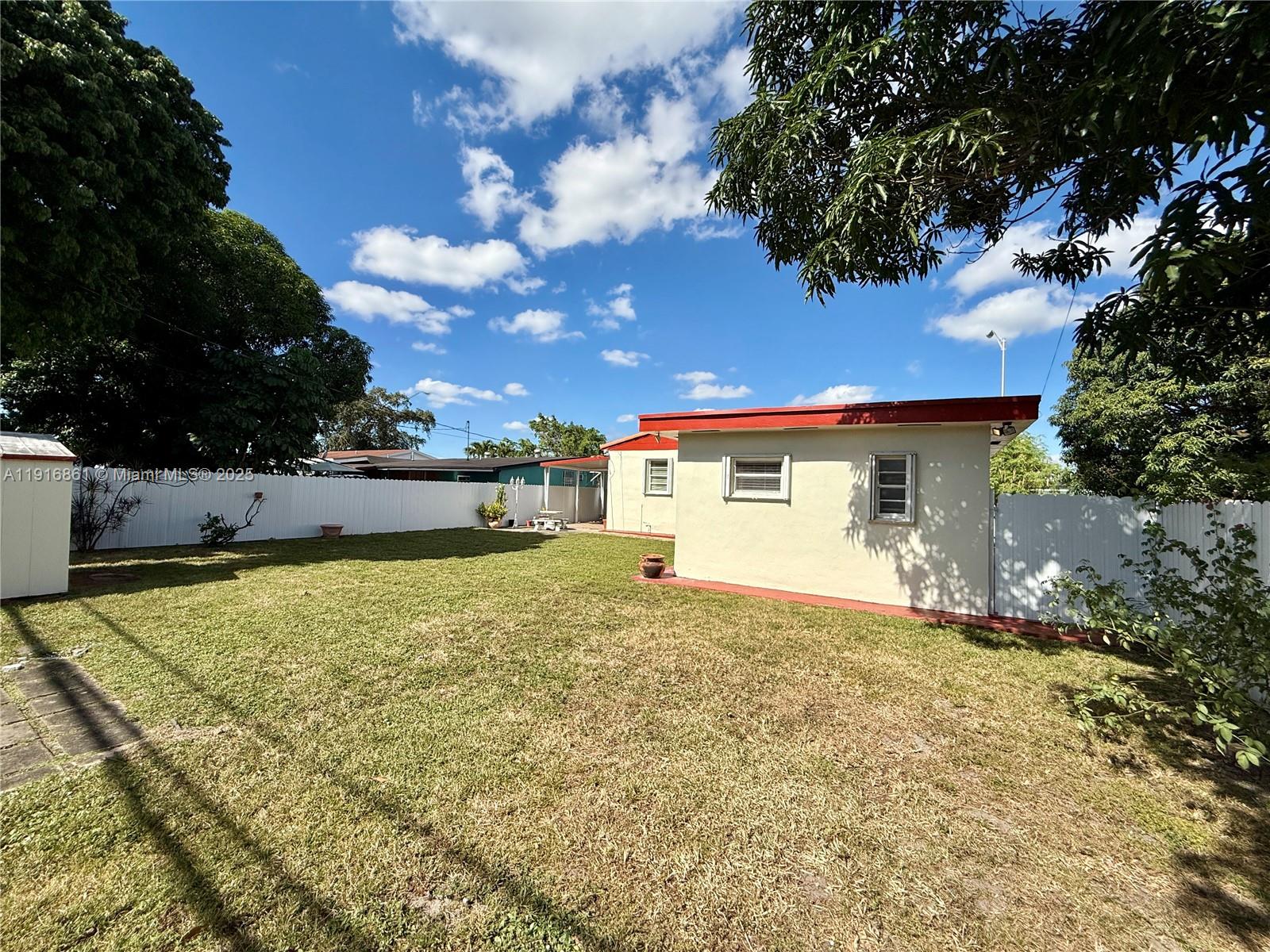174 East 41st Street Hialeah, FL 33013 - Photo 24 of 46 a view of a house with a yard and garage