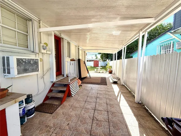a view of a porch with wooden floor and fence