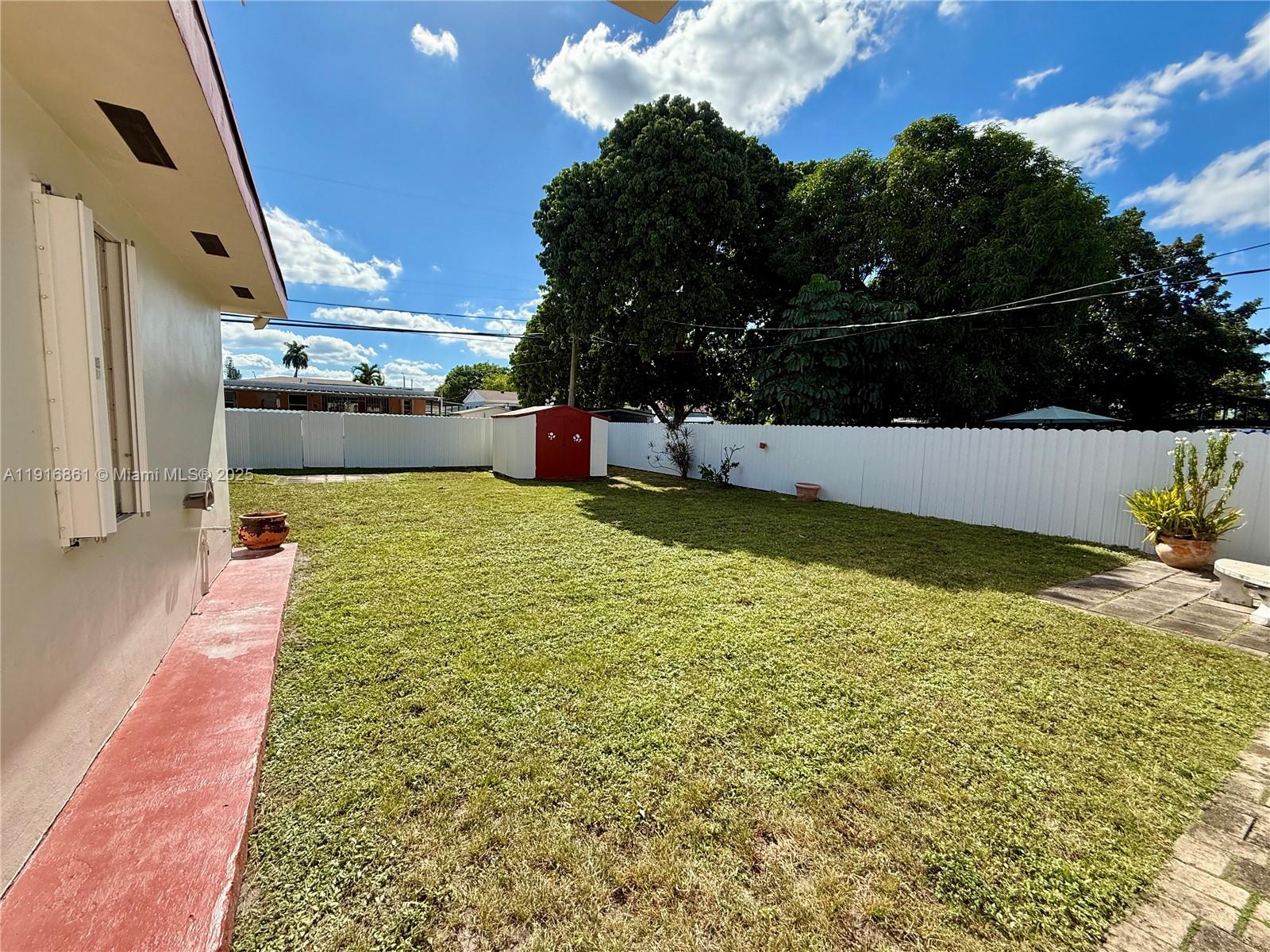 174 East 41st Street Hialeah, FL 33013 - Photo 29 of 46 a view of a swimming pool with an outdoor space and seating area