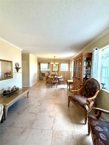 a living room with furniture gym equipment and large windows
