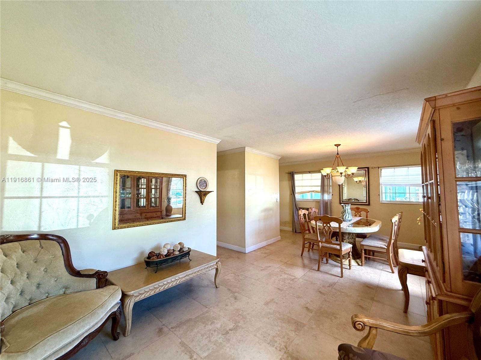 174 East 41st Street Hialeah, FL 33013 - Photo 33 of 46 a living room with furniture and a table