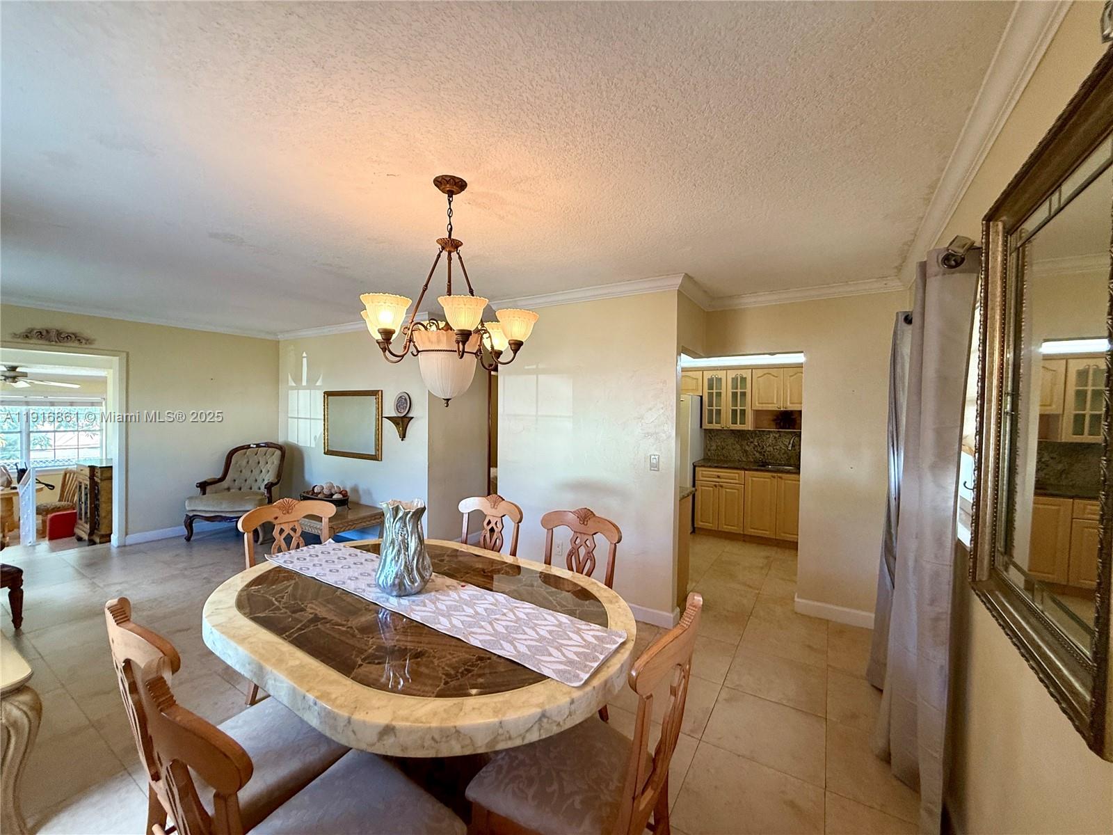 174 East 41st Street Hialeah, FL 33013 - Photo 36 of 46 a dining room with furniture a chandelier and window