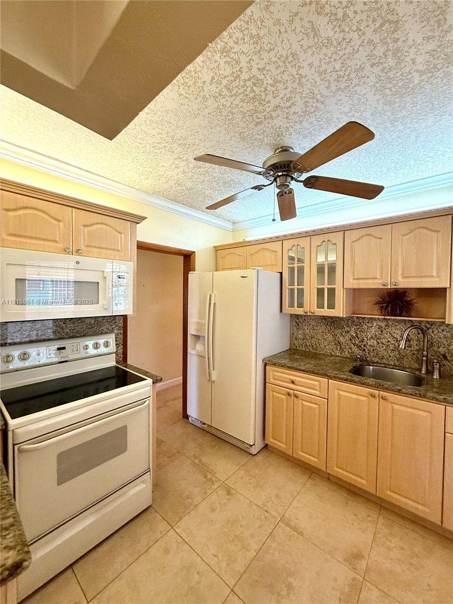 174 East 41st Street Hialeah, FL 33013 - Photo 39 of 46 a kitchen with stainless steel appliances granite countertop a stove and a refrigerator