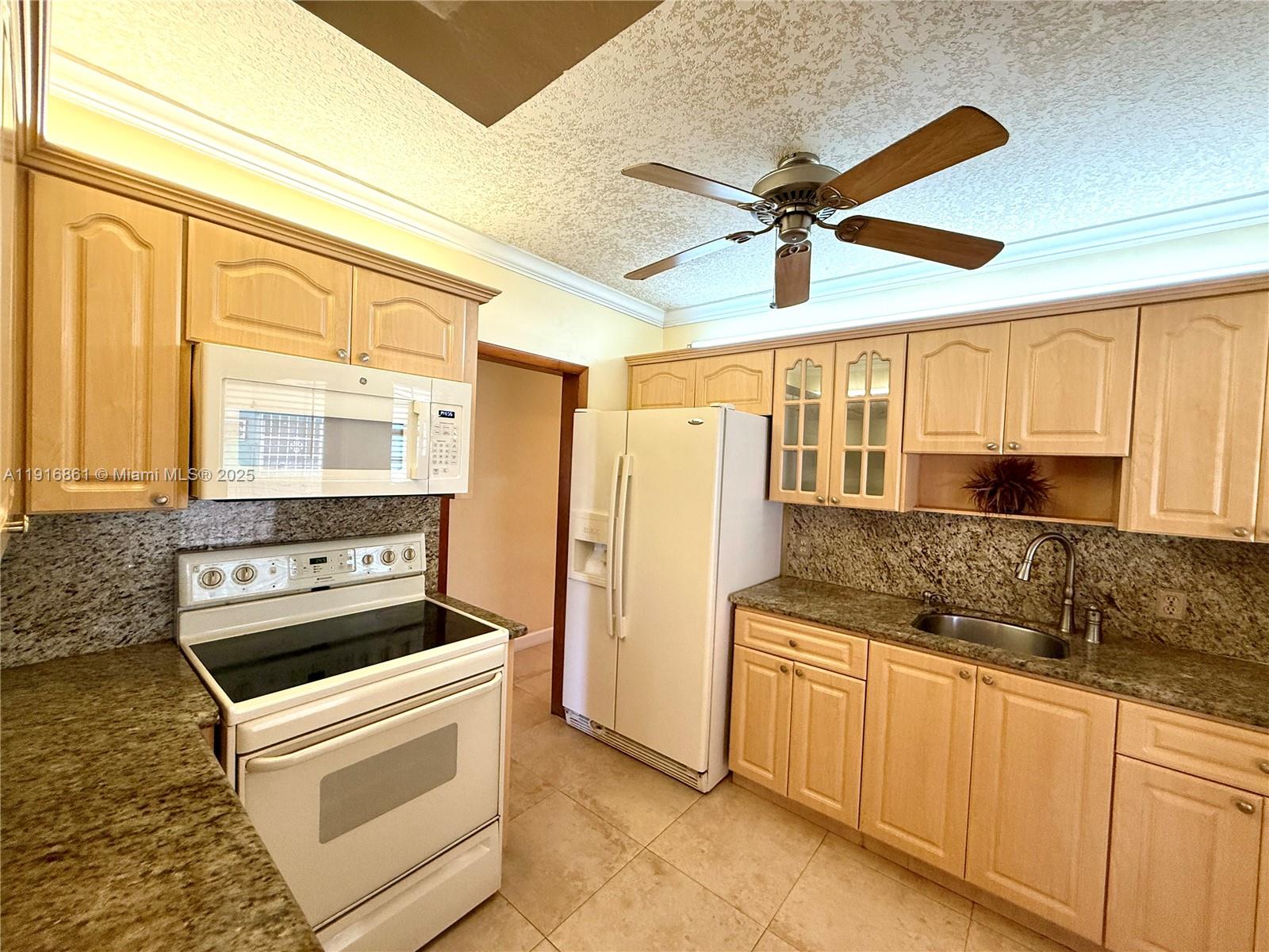 174 East 41st Street Hialeah, FL 33013 - Photo 40 of 46 a kitchen with stainless steel appliances granite countertop a stove and a sink