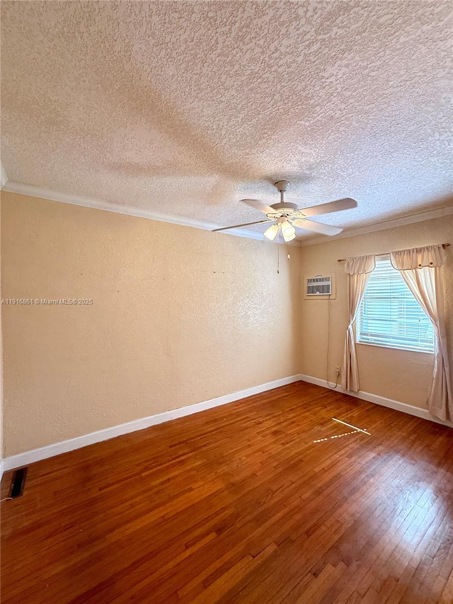 174 East 41st Street Hialeah, FL 33013 - Photo 44 of 46 a view of an empty room with wooden floor and a window