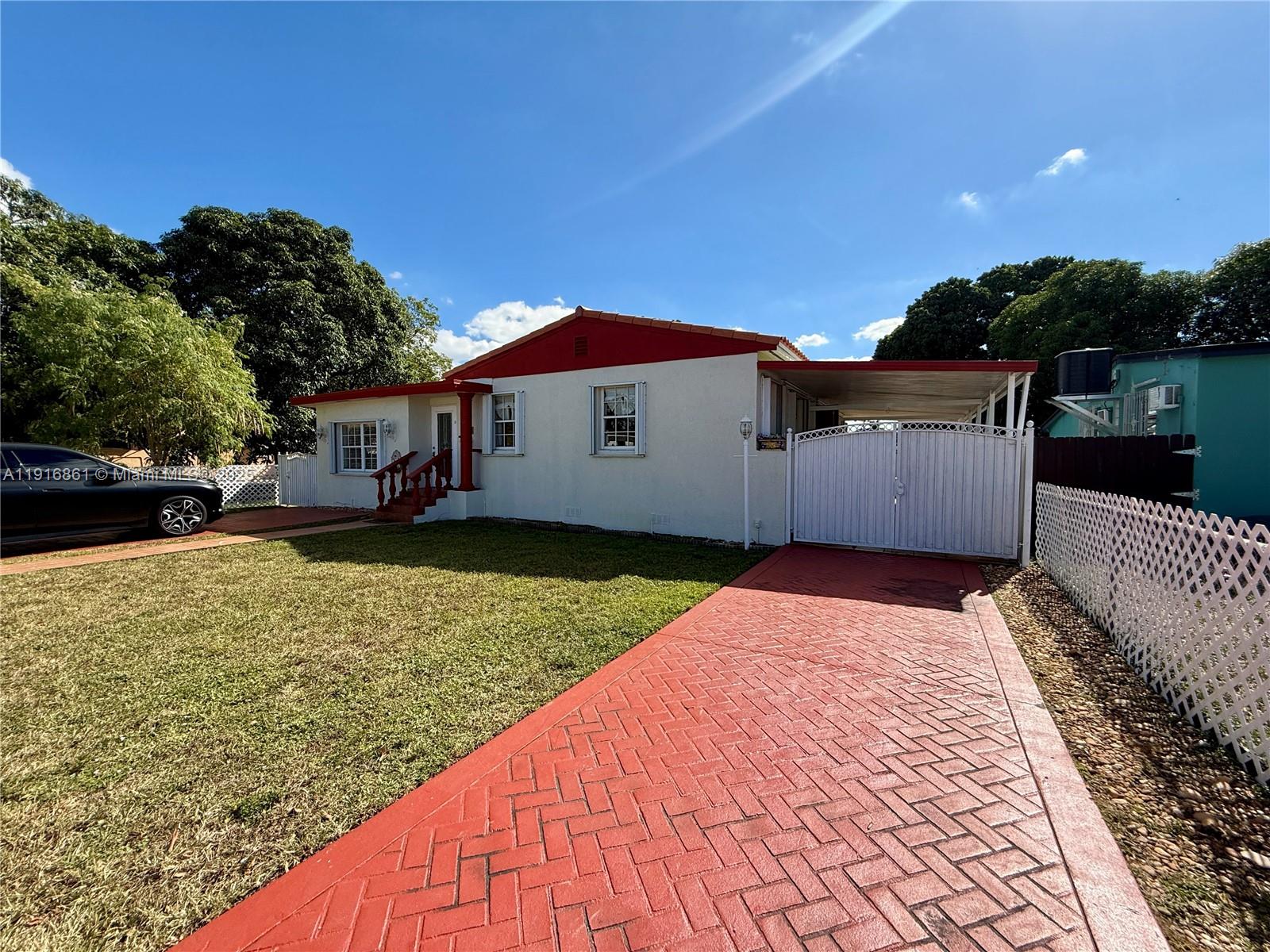 174 East 41st Street Hialeah, FL 33013 - Photo 8 of 46 a house view with a garden space