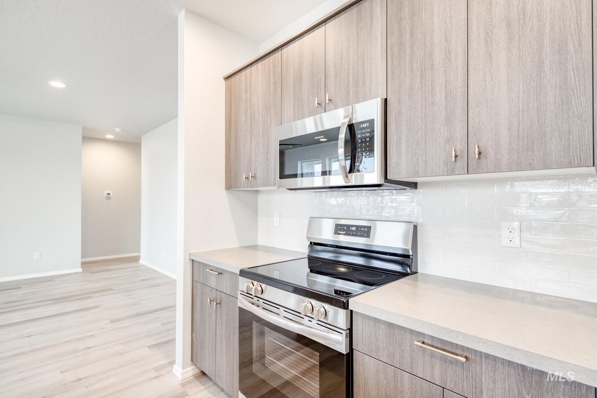 13696 Nisene Street Caldwell, ID 83607 - Photo 6 of 24 Kitchen featuring stainless steel appliances, light countertops, tasteful backsplash, modern cabinets, and recessed lighting