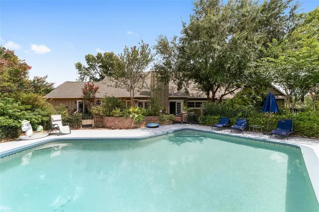 a view of a house with swimming pool and sitting area