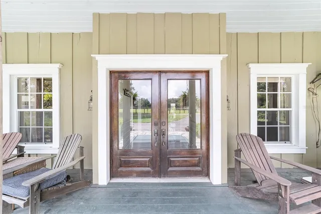 a living room with a chair and large window