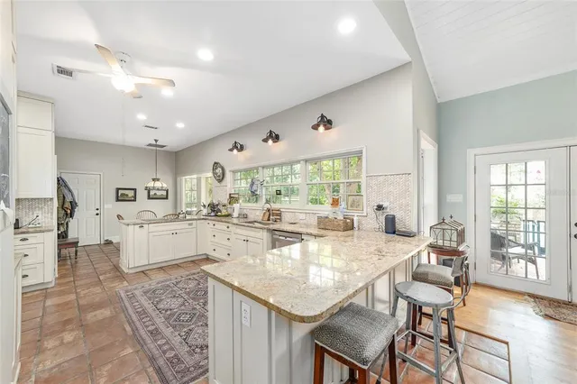 a large white kitchen with a large window