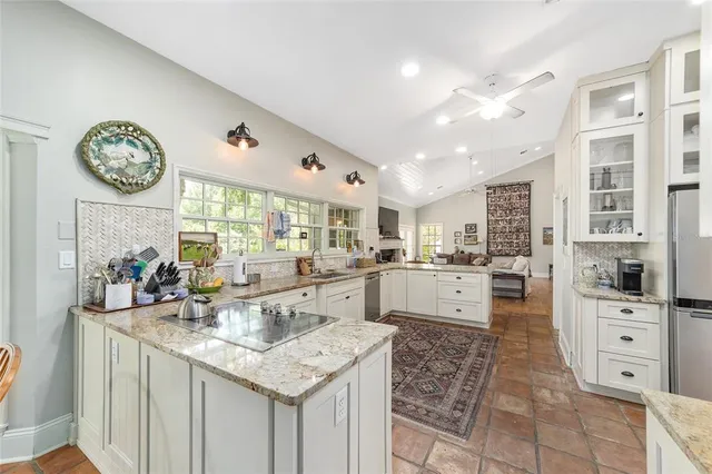 a kitchen with stainless steel appliances a refrigerator sink and cabinets