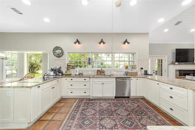 a en suite bathroom with a granite countertop sink and a mirror