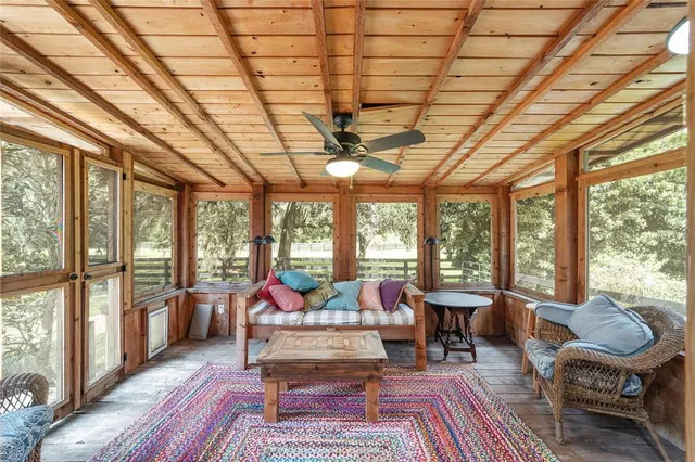 a reading room with furniture wooden floor and a book shelf