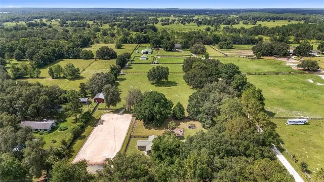 a bathroom with a sink and mirror with bathtub