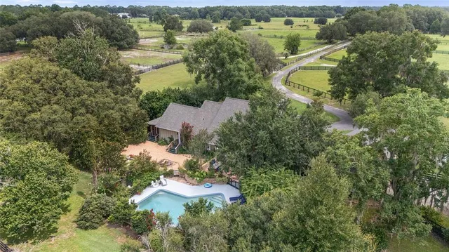 an aerial view of house with yard swimming pool and mountains