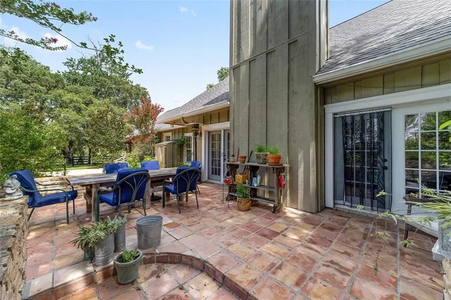 a view of a dinning tables and chairs in a patio of the house