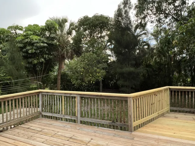 a view of a house with a yard and deck