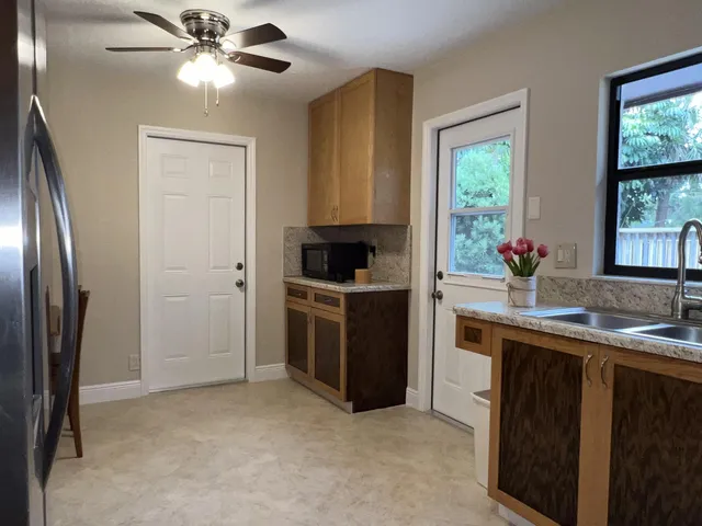 a kitchen with stainless steel appliances a stove a refrigerator and a sink