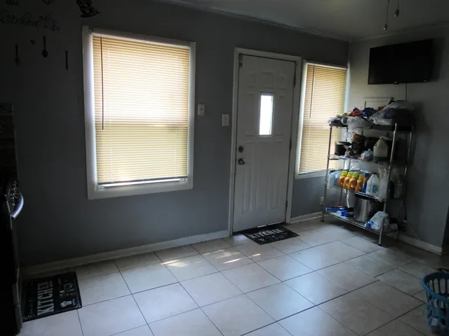 a view of an empty room with a window and storage area