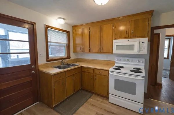 a kitchen with a stove sink and cabinets