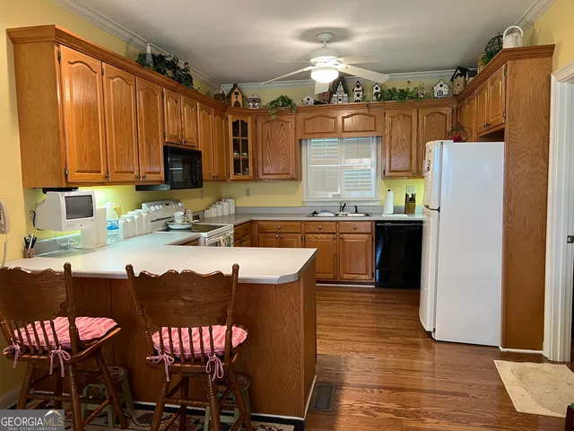 a kitchen with stainless steel appliances a stove top oven a sink and a microwave