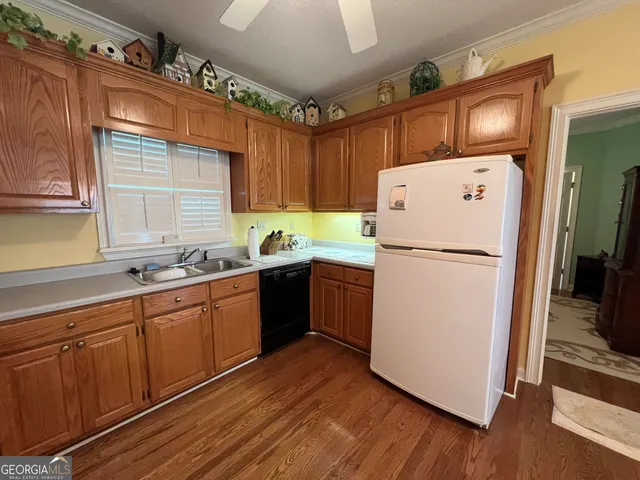 a kitchen with sink stove and cabinets