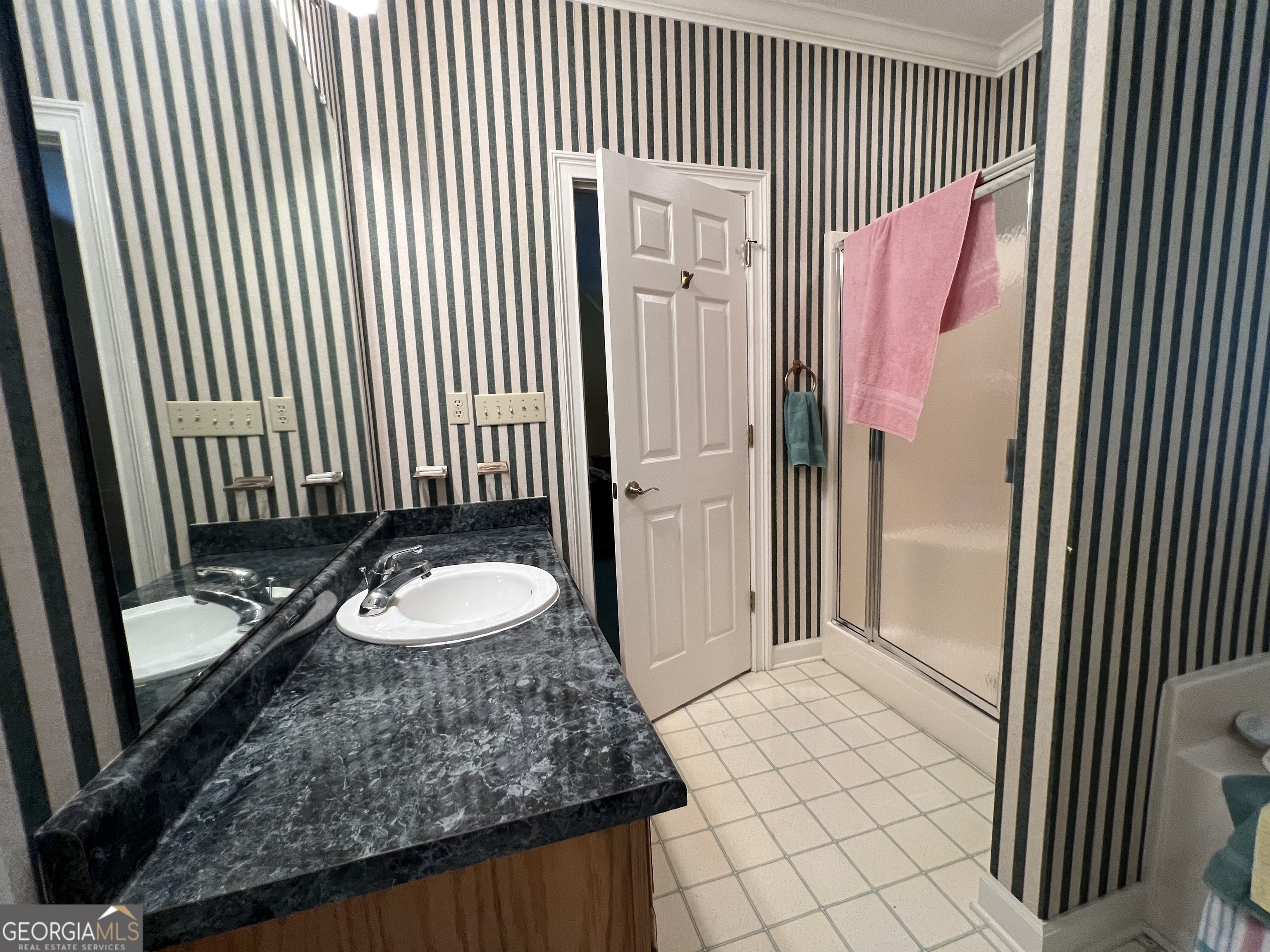 762 Nicholson-Carr Road Chester, GA 31012 - Photo 29 of 80 a bathroom with a granite countertop sink and a mirror