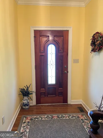 a living room with fireplace furniture and a potted plant