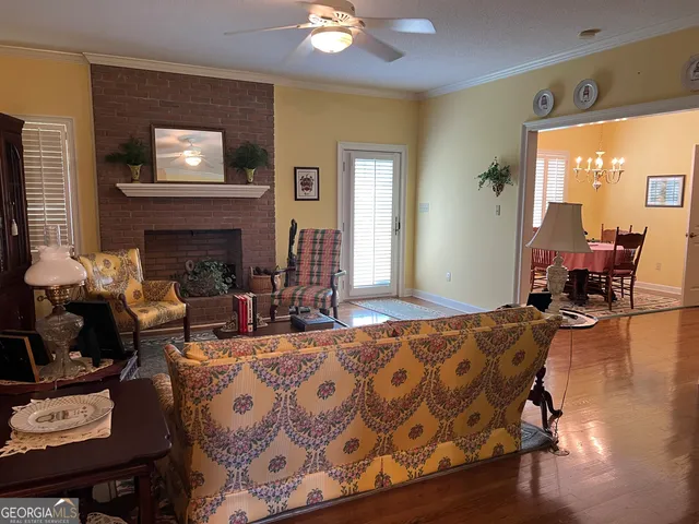 a view of a dining room with furniture and chandelier