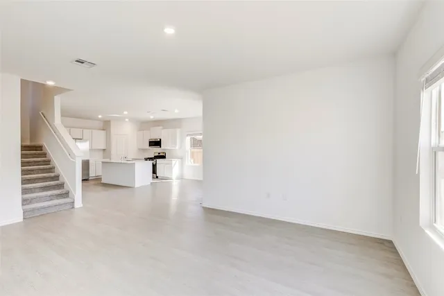 a view of a living room hardwood and kitchen view