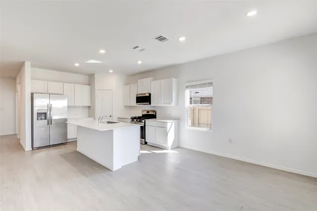 a view of kitchen with stainless steel appliances refrigerator oven and microwave