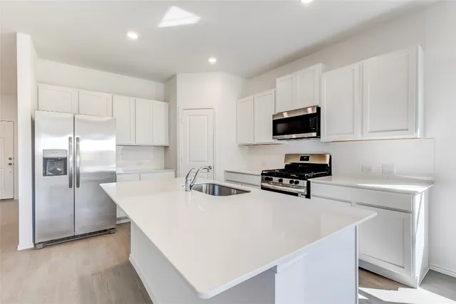 a view of a kitchen with microwave and cabinets