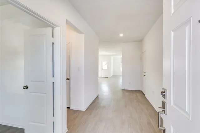 a view of a hallway with wooden floor