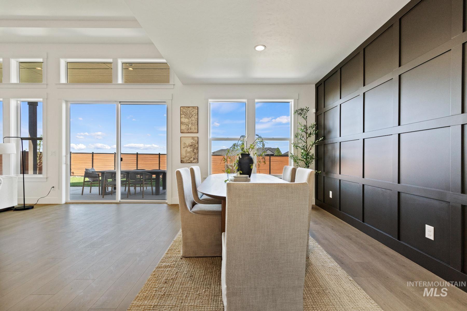 8650 West Inspirado Street Meridian, ID 83646 - Photo 13 of 30 Dining area with light wood-style flooring, a decorative wall, and recessed lighting