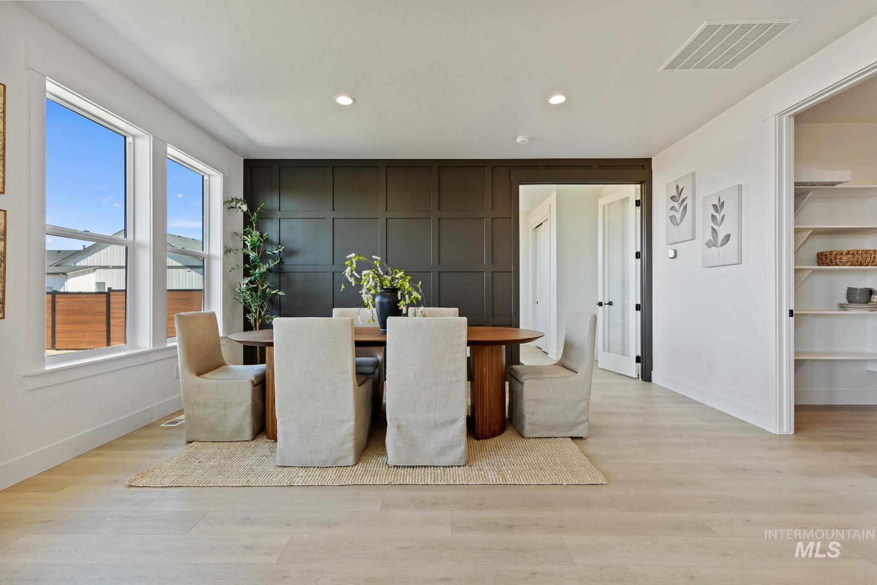 8650 West Inspirado Street Meridian, ID 83646 - Photo 14 of 30 Dining area with light wood finished floors, recessed lighting, and a decorative wall